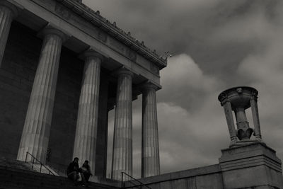 Low angle view of historical building against cloudy sky