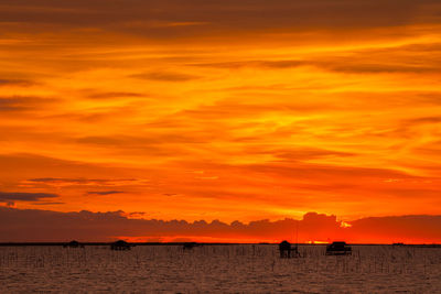 Scenic view of sea against orange sky