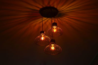 Low angle view of light bulbs hanging on ceiling
