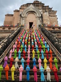 Low angle view of multi colored umbrellas outside building