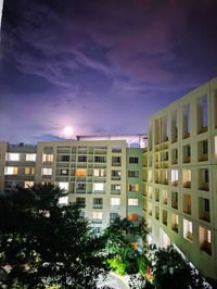 Buildings in city against sky at night