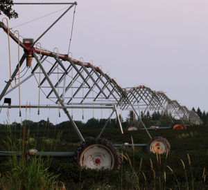 Traditional windmill on field against clear sky