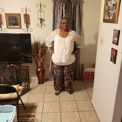 Portrait of woman standing on tiled floor at home