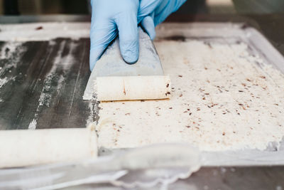 Cropped hand of person preparing ice cream