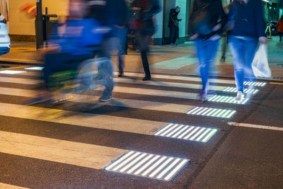 Blurred motion of people walking on road