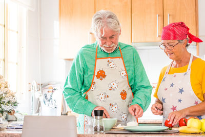 Man and woman holding food on table