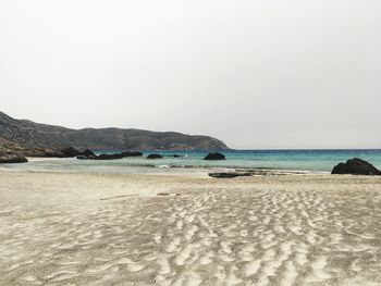 Scenic view of beach against clear sky