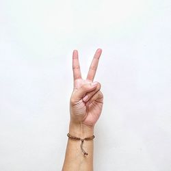 Close-up of hand holding over white background