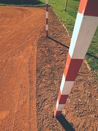 Detail of gate frame . outdoor football or handball playground. red crushed bricks surface on ground