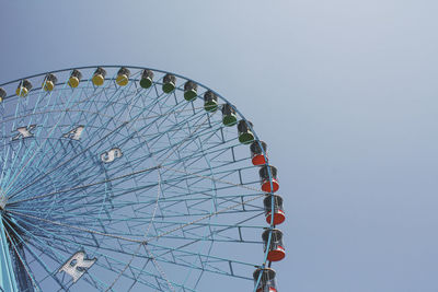 Low angle view of ferris wheel against clear sky