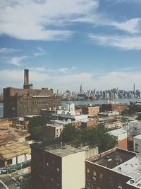 Buildings against cloudy sky