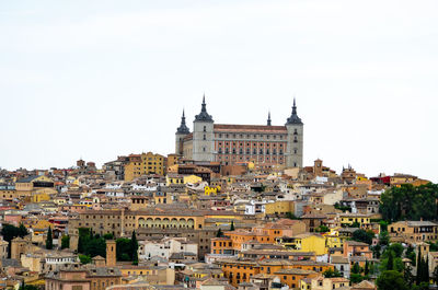 Buildings in city against clear sky