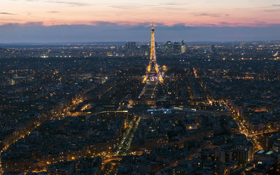 Aerial view of city lit up at night