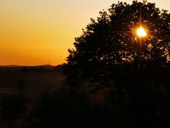 Silhouette trees against sky during sunset