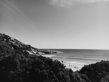 View of calm beach against clear sky