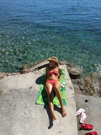 Young woman in bikini resting at beach