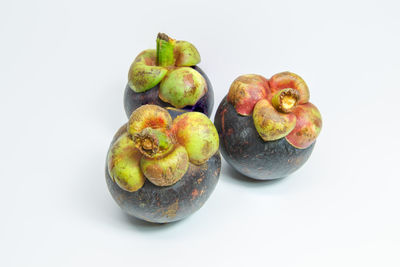 Close-up of fruits against white background