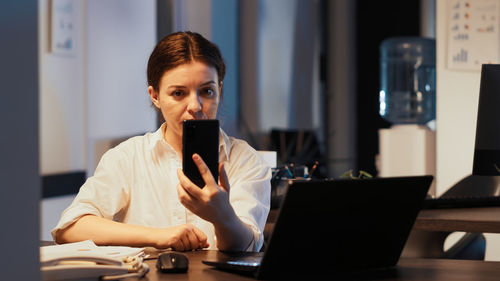 Young woman using laptop at table