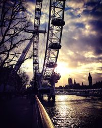 View of bridge over river against cloudy sky