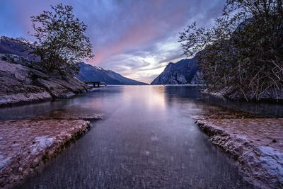 Scenic view of lake garda against sky during sunset