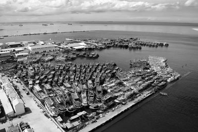 High angle view of harbor by sea against sky