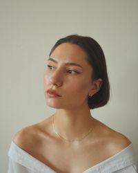 Portrait of a young woman against white background