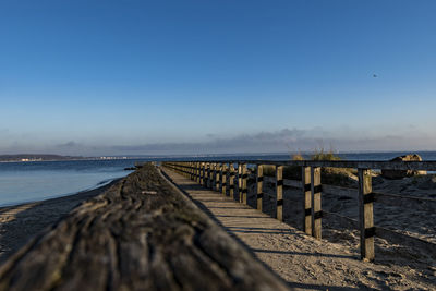 Pier over sea against clear sky