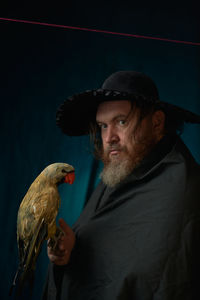 Portrait of man with bird