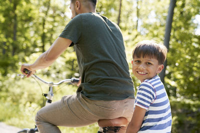 Side view of boy riding bicycle