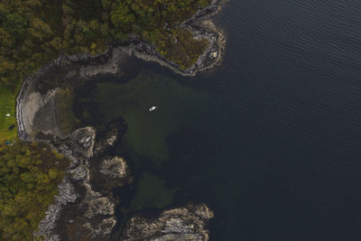 High angle view of rocks on sea shore