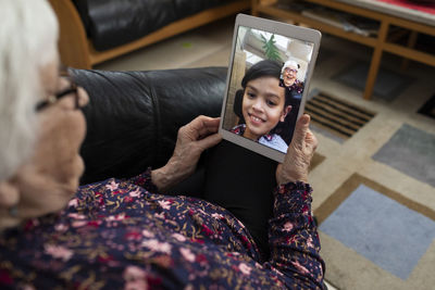 Hands holding digital tablet during video call