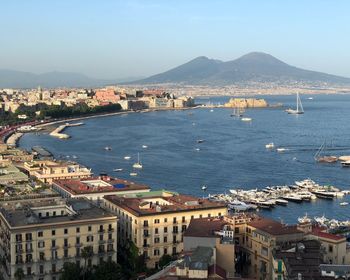 High angle view of townscape by sea against sky