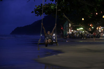 Woman on swing at night