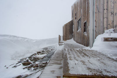 Snow covered road against sky