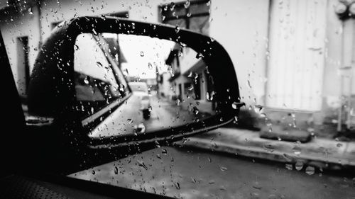 Cars on road seen through wet window