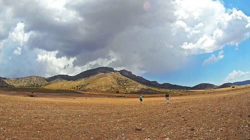 Scenic view of landscape against cloudy sky