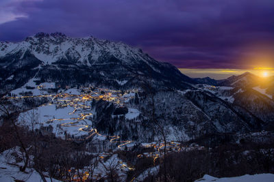 Scenic view of snowcapped mountains against sky during sunset