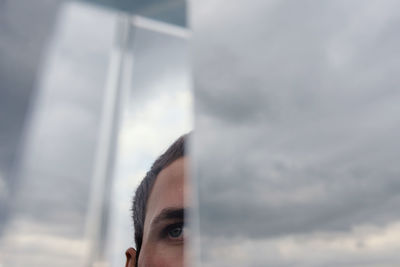 Close-up portrait of man against sky