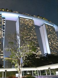 Low angle view of illuminated building against sky at night