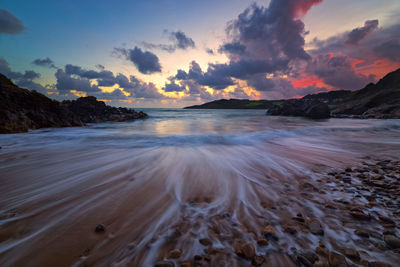 Scenic view of dramatic sky over sea with long exposure