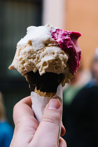 Close-up of hand holding ice cream cone