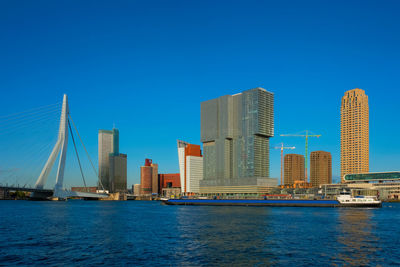 Rotterdam skyscrapers skyline and erasmusbrug bridge over of nieuwe maas river. rotterdam