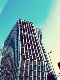 Low angle view of office building against blue sky