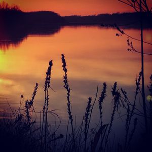 Scenic view of lake against sky during sunset