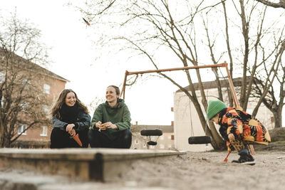 Women with daughter at sand pit