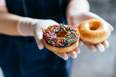 Midsection of woman holding donut