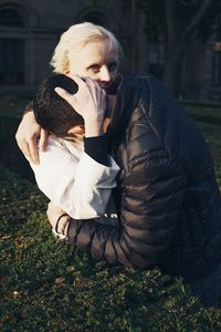 Portrait of woman with arms raised on field