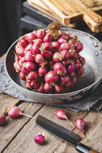 Close-up of onions in container on table