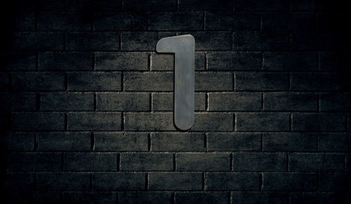 Number 1 on brick wall at night