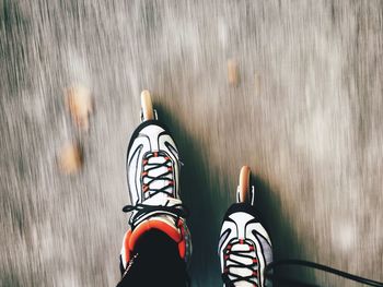 Low section of person inline skating on road